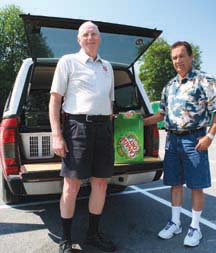 MONEY FOR BOTTLES: Raymond Poissant (at right) helps the cause by turning in empties to Salvation Army Corps Sergeant Major Al Bezanson.